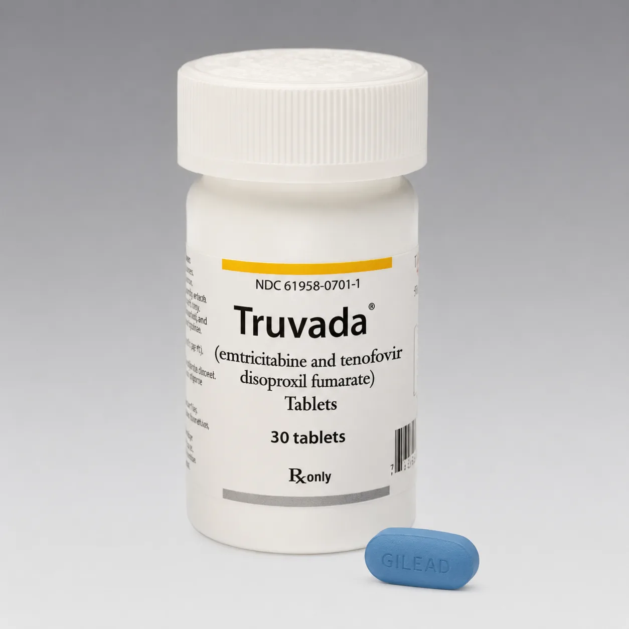 A bottle of Truvada tablets with two blue tablets beside it